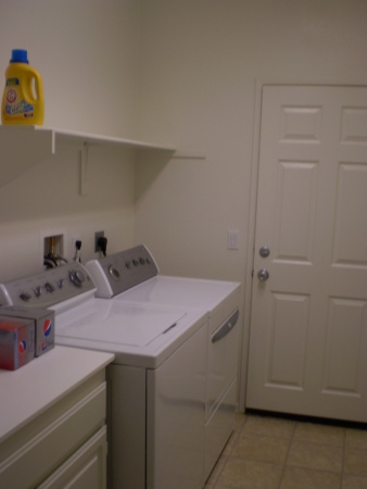 Utility Room with Shelf/Cabinets and Washer/Dryer provided